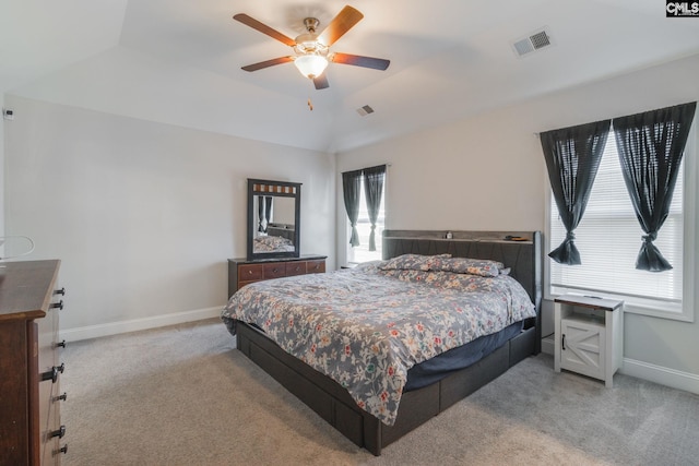 carpeted bedroom with vaulted ceiling, baseboards, visible vents, and ceiling fan