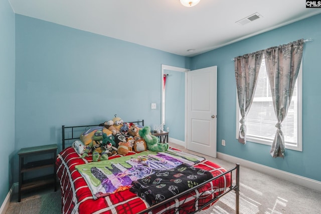 carpeted bedroom with baseboards and visible vents