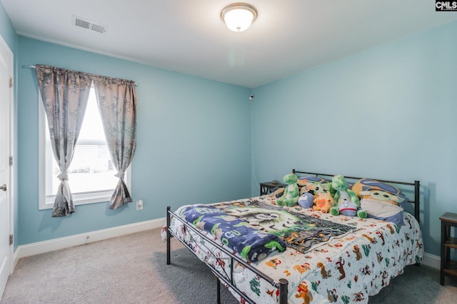 carpeted bedroom featuring visible vents and baseboards