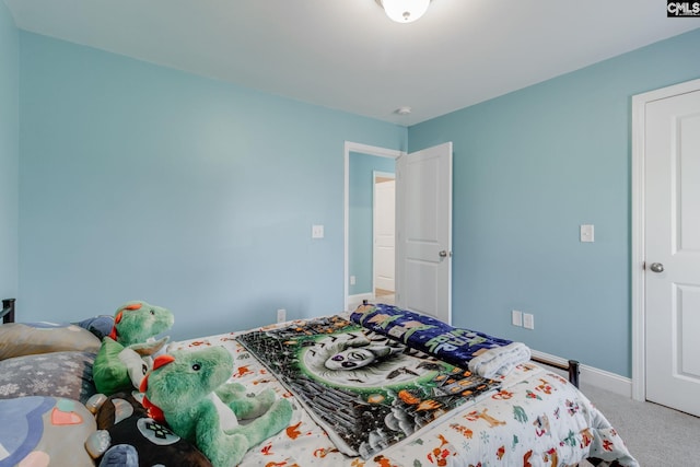 carpeted bedroom featuring baseboards