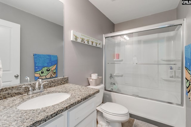 bathroom featuring vanity, toilet, and shower / bath combination with glass door