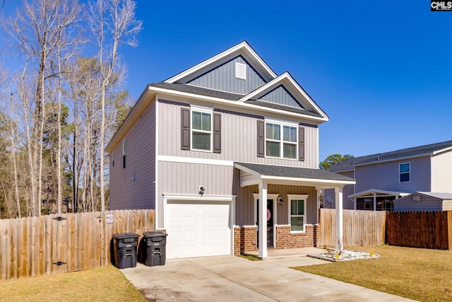 craftsman inspired home featuring a front yard, fence, concrete driveway, a garage, and brick siding