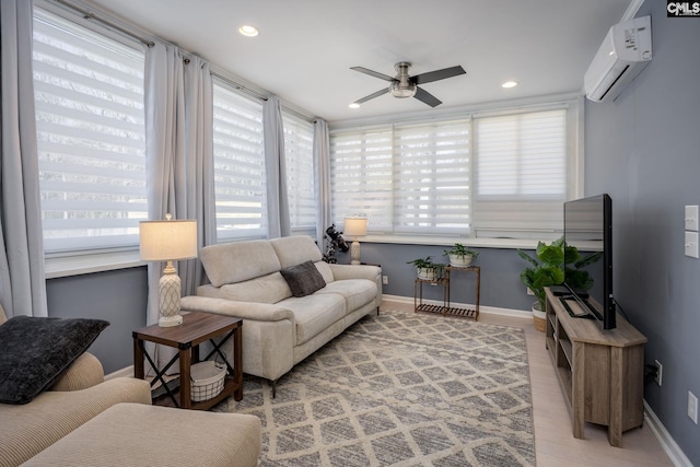 living room featuring a wealth of natural light, baseboards, an AC wall unit, and ceiling fan