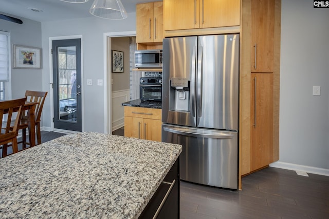 kitchen featuring light stone counters, stainless steel appliances, baseboards, and dark wood-style flooring