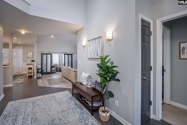 hallway featuring baseboards and wood finished floors