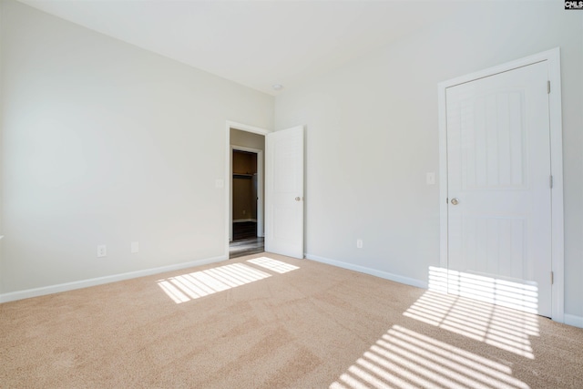 unfurnished bedroom featuring baseboards and carpet