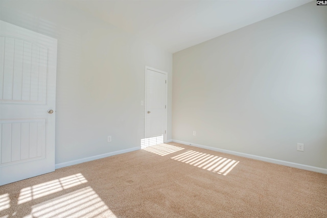 unfurnished room featuring baseboards and carpet floors