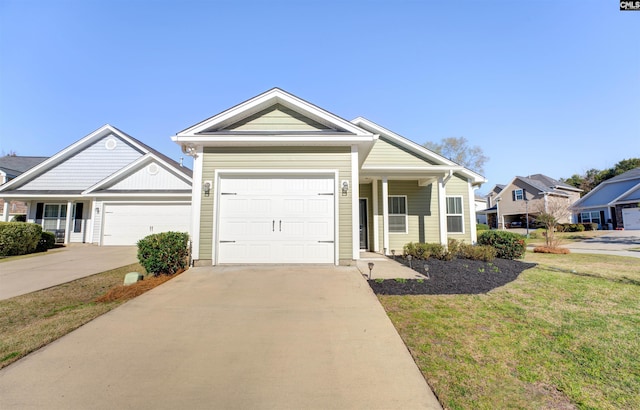 view of front of house featuring a garage, concrete driveway, and a front lawn