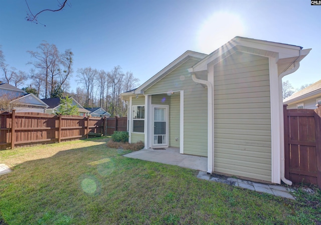 back of property featuring a patio area, a lawn, and a fenced backyard