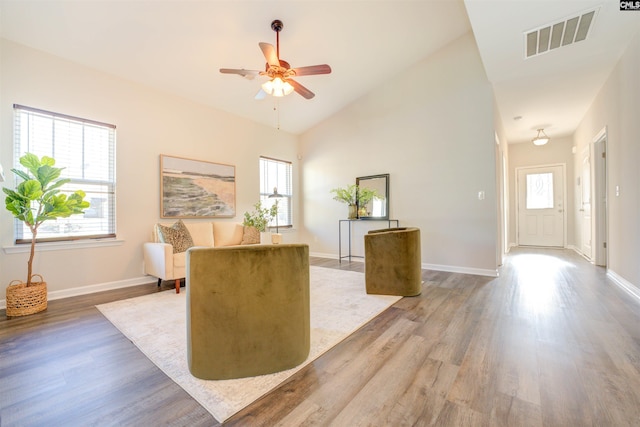 unfurnished office with wood finished floors, a healthy amount of sunlight, visible vents, and ceiling fan