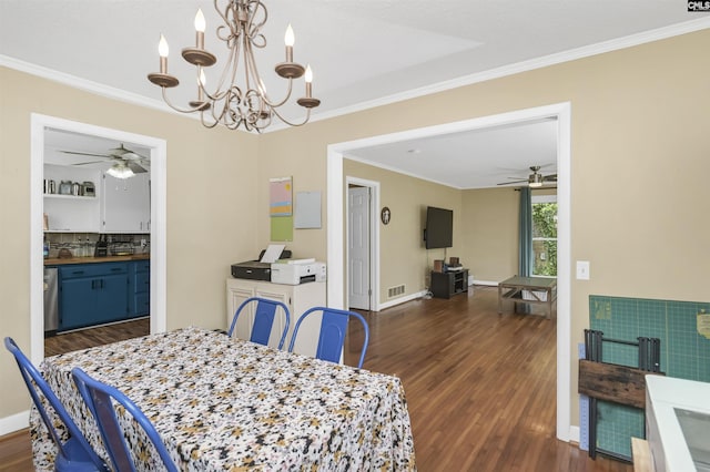 dining room featuring dark wood-type flooring, crown molding, ceiling fan with notable chandelier, and visible vents