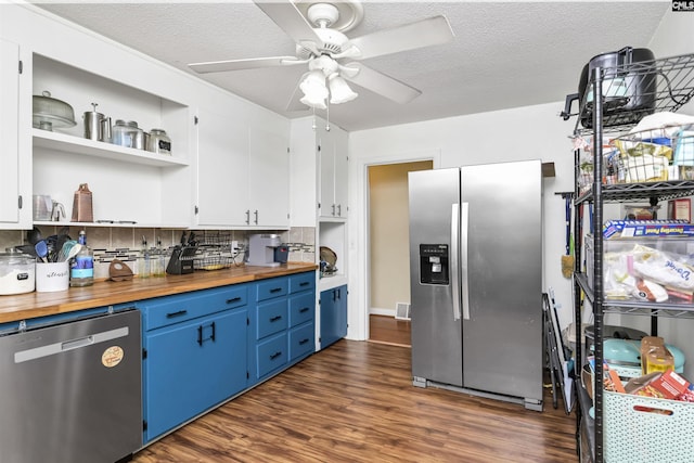 kitchen with blue cabinets, dark wood-type flooring, wood counters, stainless steel appliances, and ceiling fan