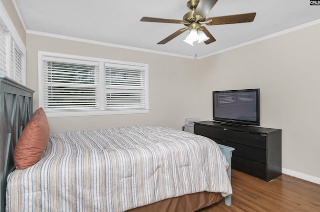 bedroom featuring crown molding, wood finished floors, baseboards, and ceiling fan