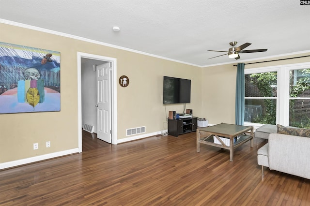 living area featuring visible vents, ornamental molding, ceiling fan, and wood finished floors