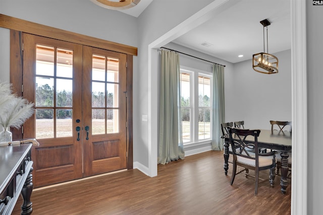 entryway featuring french doors, baseboards, a notable chandelier, and wood finished floors