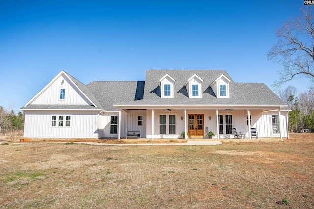 view of front of house with board and batten siding, french doors, a ceiling fan, and roof with shingles