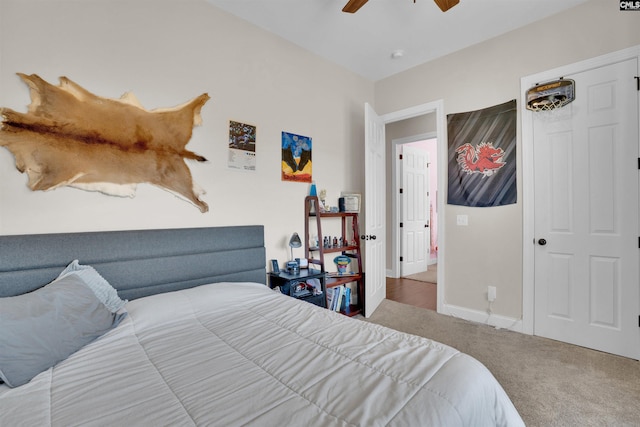 carpeted bedroom featuring baseboards and ceiling fan