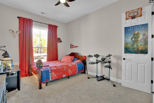 carpeted bedroom featuring visible vents, baseboards, and a ceiling fan