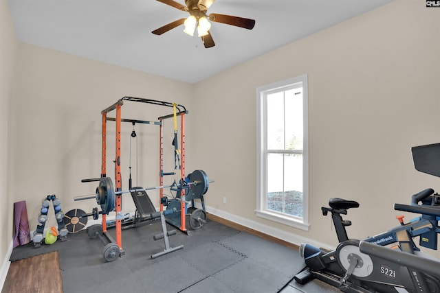 workout area featuring baseboards and ceiling fan