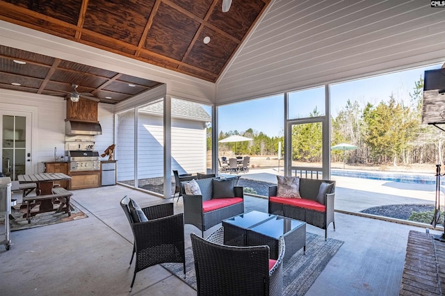 view of patio / terrace with area for grilling, outdoor dining space, outdoor lounge area, an outdoor pool, and an outdoor kitchen