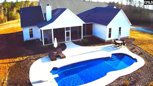 pool featuring a patio area and a sunroom