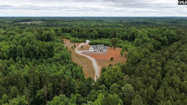 birds eye view of property featuring a view of trees