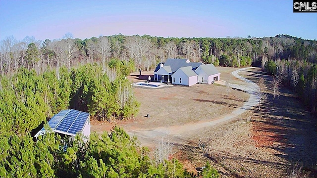 drone / aerial view featuring a wooded view