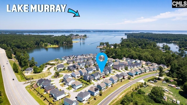 bird's eye view featuring a residential view, a wooded view, and a water view