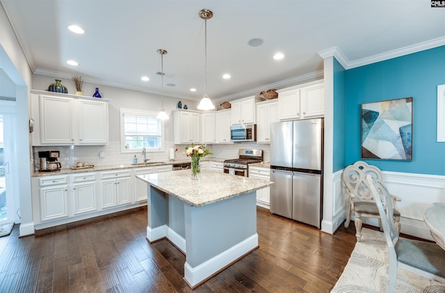 kitchen featuring a sink, stainless steel appliances, dark wood-type flooring, and white cabinetry