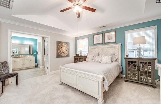 bedroom featuring visible vents, lofted ceiling, light colored carpet, and baseboards