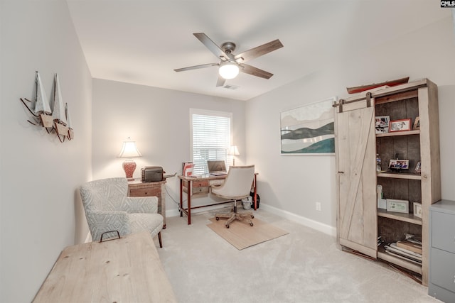 carpeted office with baseboards and a ceiling fan