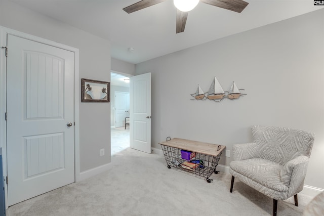 sitting room with baseboards, carpet, and ceiling fan