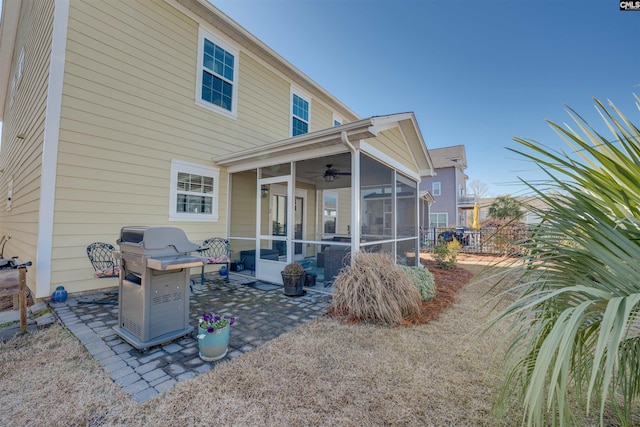 back of property with a patio, fence, and a sunroom