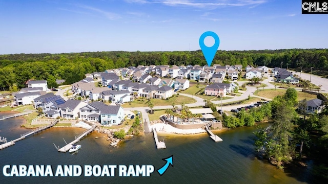 bird's eye view with a wooded view, a residential view, and a water view