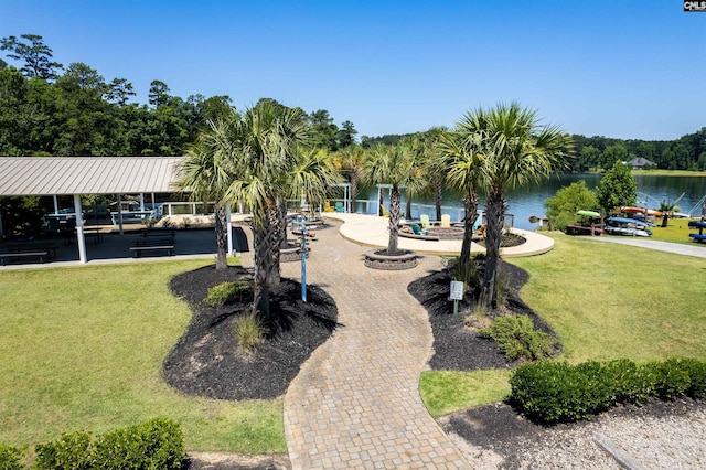 view of community featuring a lawn and a water view