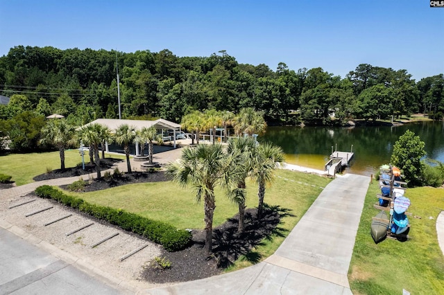 view of community featuring a gazebo, a dock, a yard, and a water view