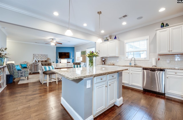 kitchen featuring visible vents, dishwasher, dark wood-type flooring, and a sink