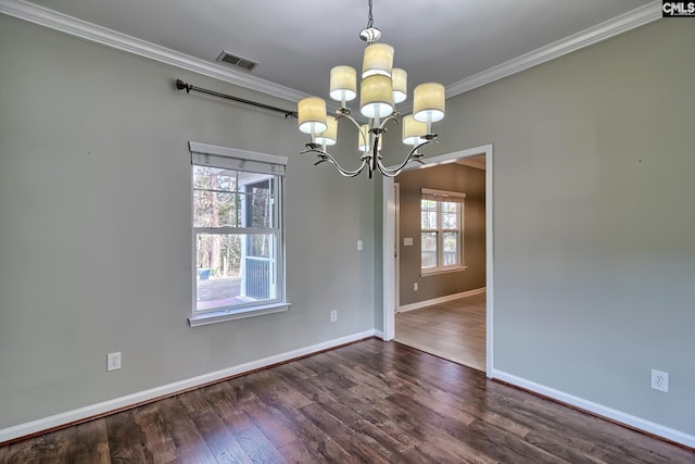 spare room with wood finished floors, visible vents, baseboards, ornamental molding, and a notable chandelier