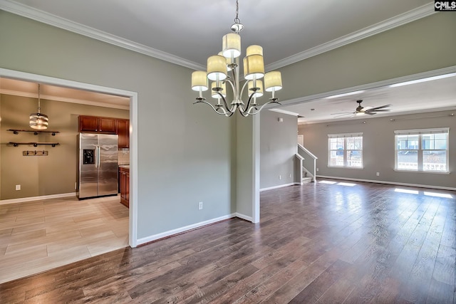 spare room with stairway, ceiling fan with notable chandelier, ornamental molding, and light wood finished floors