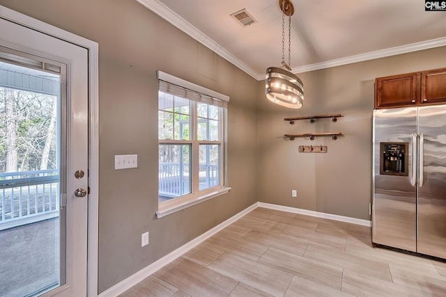 kitchen with brown cabinetry, visible vents, stainless steel refrigerator with ice dispenser, and ornamental molding