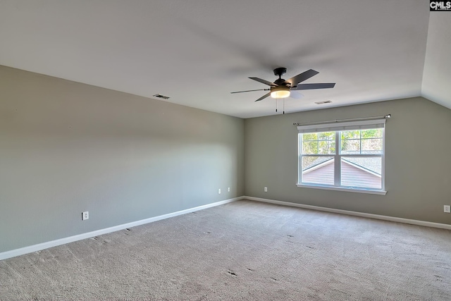 empty room with baseboards, visible vents, carpet floors, and ceiling fan