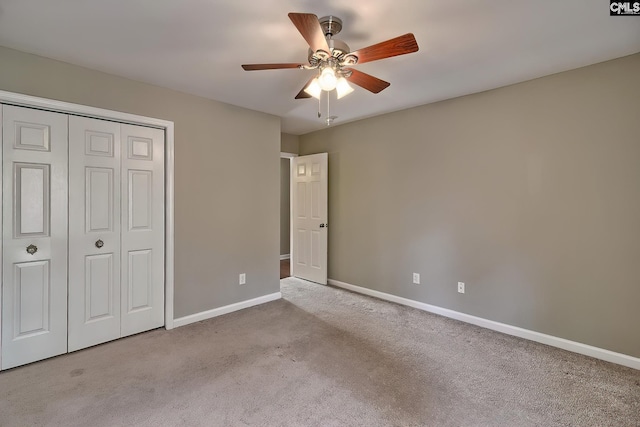 unfurnished bedroom featuring carpet flooring, a ceiling fan, baseboards, and a closet