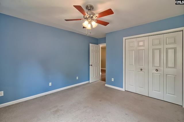 unfurnished bedroom with a closet, carpet flooring, a ceiling fan, and baseboards