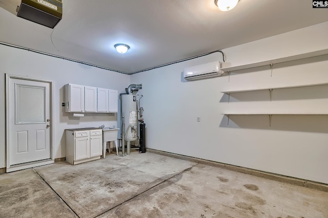 garage featuring gas water heater, an AC wall unit, and a sink