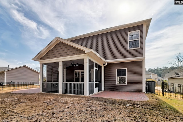 back of house featuring a ceiling fan, a patio, fence, and a sunroom