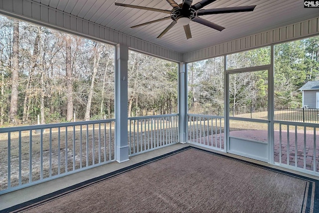 unfurnished sunroom featuring wooden ceiling and ceiling fan