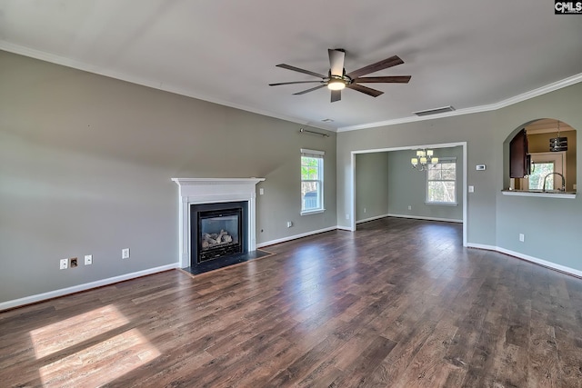 unfurnished living room featuring visible vents, a healthy amount of sunlight, dark wood finished floors, and ceiling fan with notable chandelier