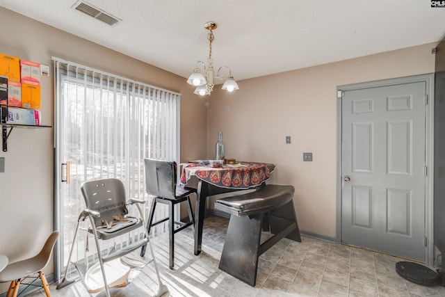 dining area featuring an inviting chandelier, baseboards, visible vents, and a textured ceiling