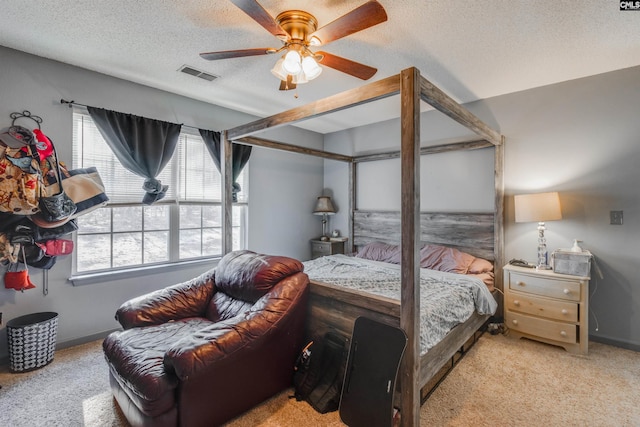 carpeted bedroom with baseboards, visible vents, a textured ceiling, and ceiling fan