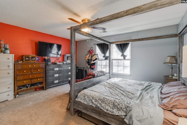 carpeted bedroom with ceiling fan, beamed ceiling, and a textured ceiling